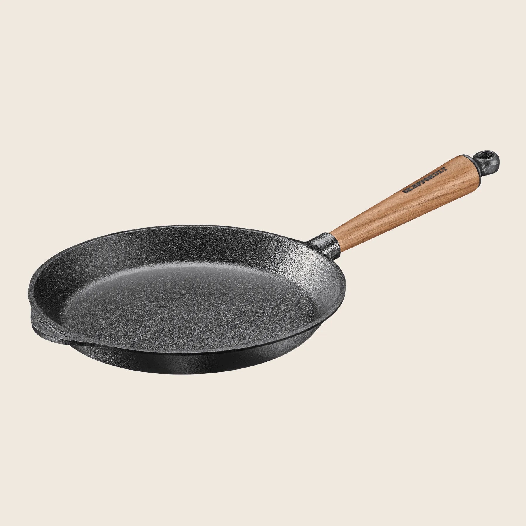 The Skeppshult Skillet With Walnut Handle 9.5 offers superior heat conduction, elegantly set against a plain background.