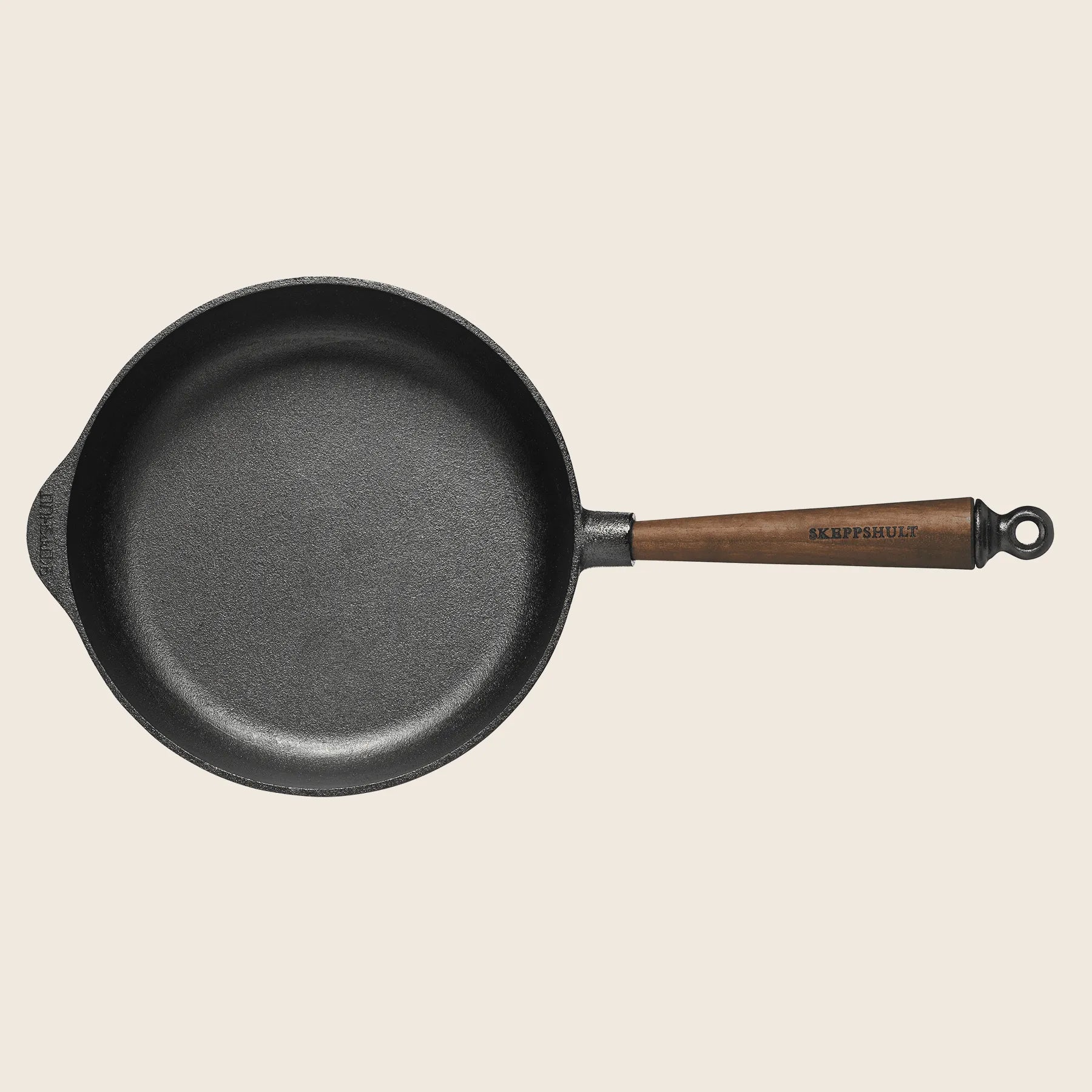 The Skeppshult Deep Skillet with a 9.75 walnut handle, handcrafted in Sweden, features a non-stick surface for effortless cooking and is shown from above on a plain background.