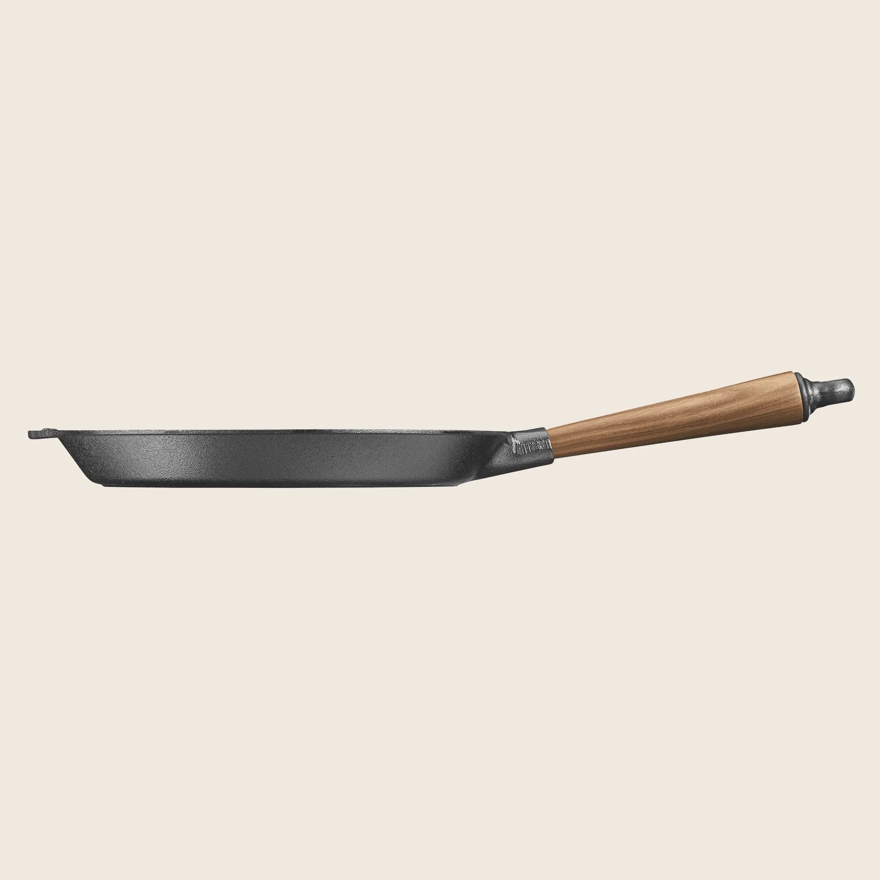 The Skeppshult Skillet With 11 Walnut Handle is shown in a side view, positioned horizontally against a plain background.