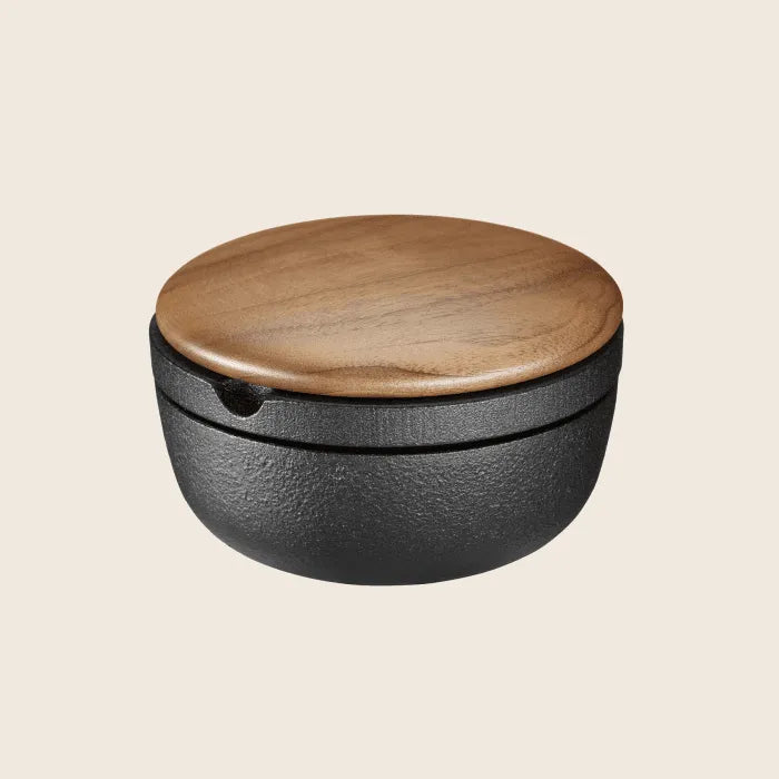 Black round container featuring a walnut lid from the Skeppshult: Big Swing Spice Mill.