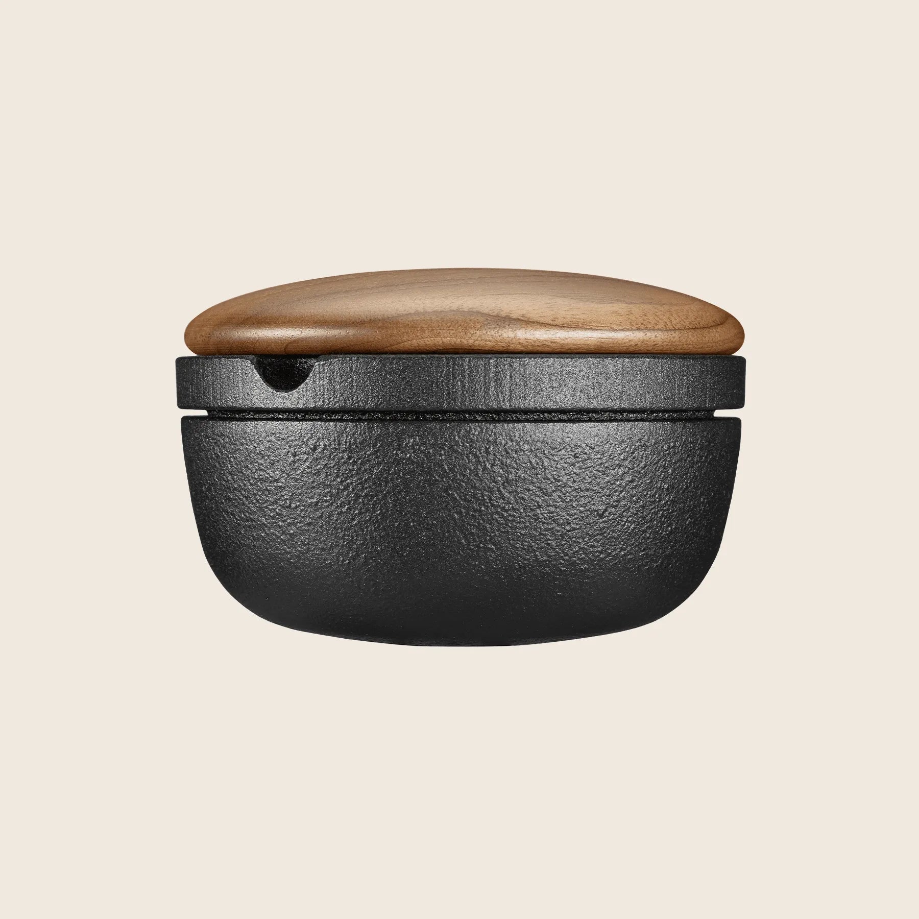 Black and wood grain Skeppshult Big Swing Spice Mill, featuring a walnut lid, sits on a neutral background.