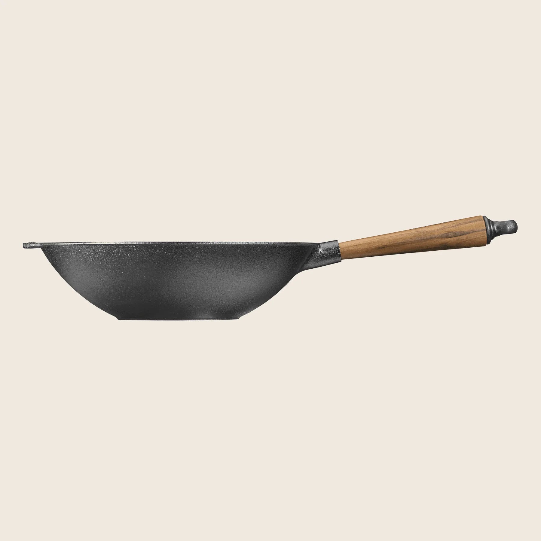 The Skeppshult Wok with Walnut Handle (12.2/30 cm) is shown from the side against a plain light background, highlighting its durable black cast iron construction and non-stick surface for effortless cooking.