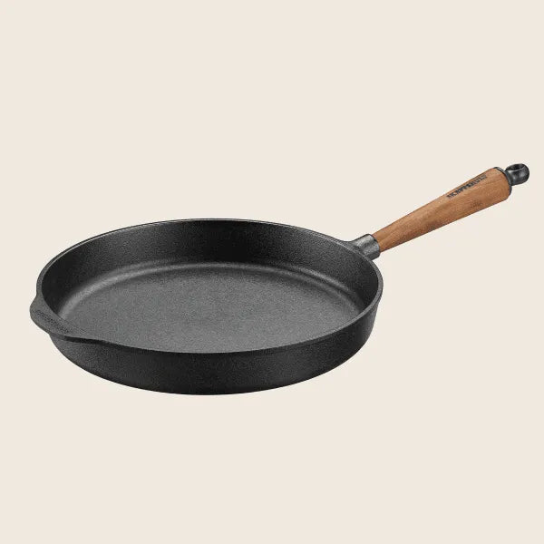 The Skeppshult 11.8 Deep Skillet features a walnut handle, shown from the side against a plain background, and is handcrafted in Sweden.