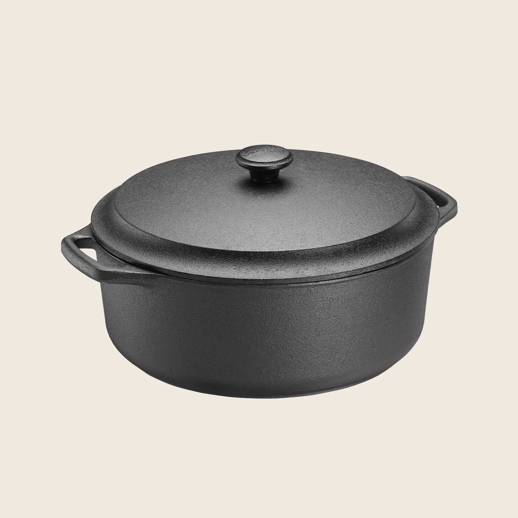 A Skeppshult 5.8 qt black cast iron Dutch oven with a non-stick surface and side handles sits against a plain background.