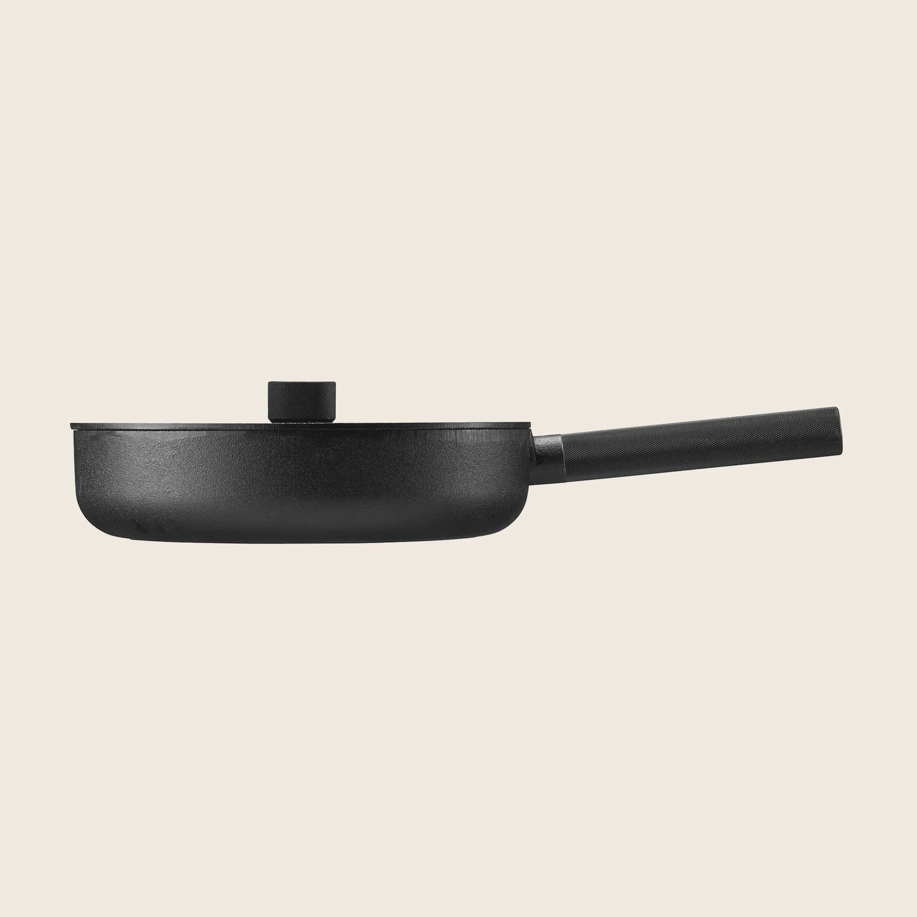 Side view of the black cast iron Skeppshult: Deep Skillet 11 / 28 cm with a lid and long handle, placed against a plain background.