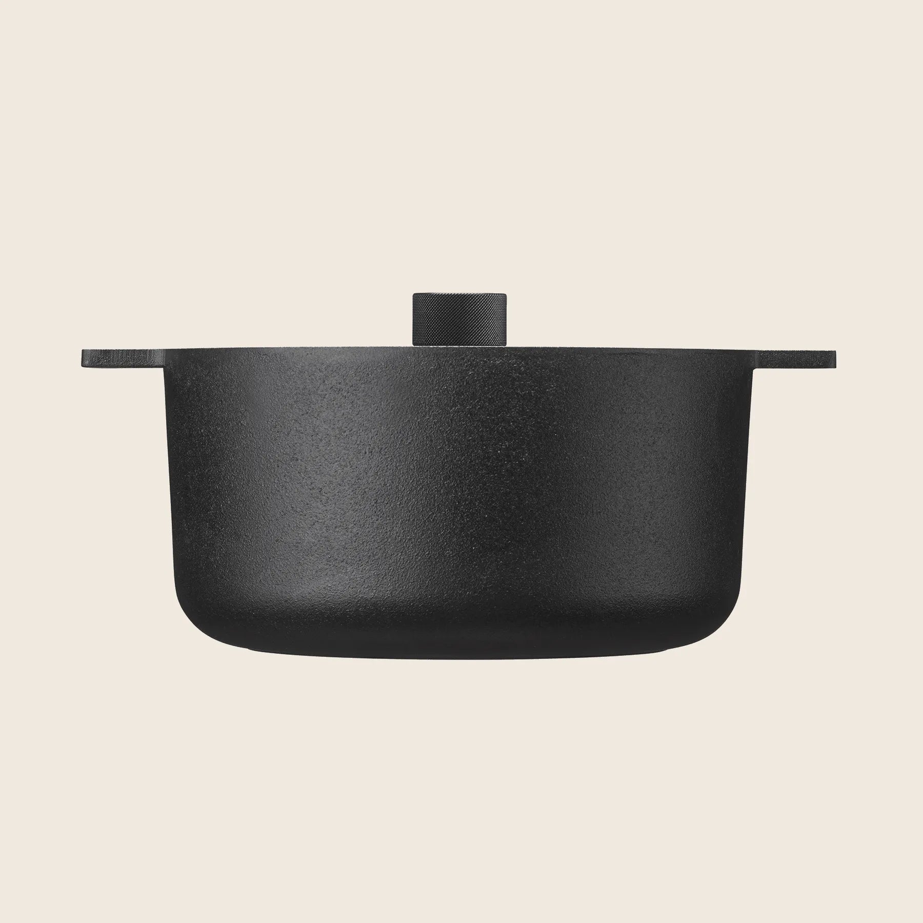 The Skeppshult Dutch Oven With Cast Iron Lid (5.25 qt / 5 L) is crafted from black cast iron with sturdy handles and a snug lid, elegantly set against a light background.