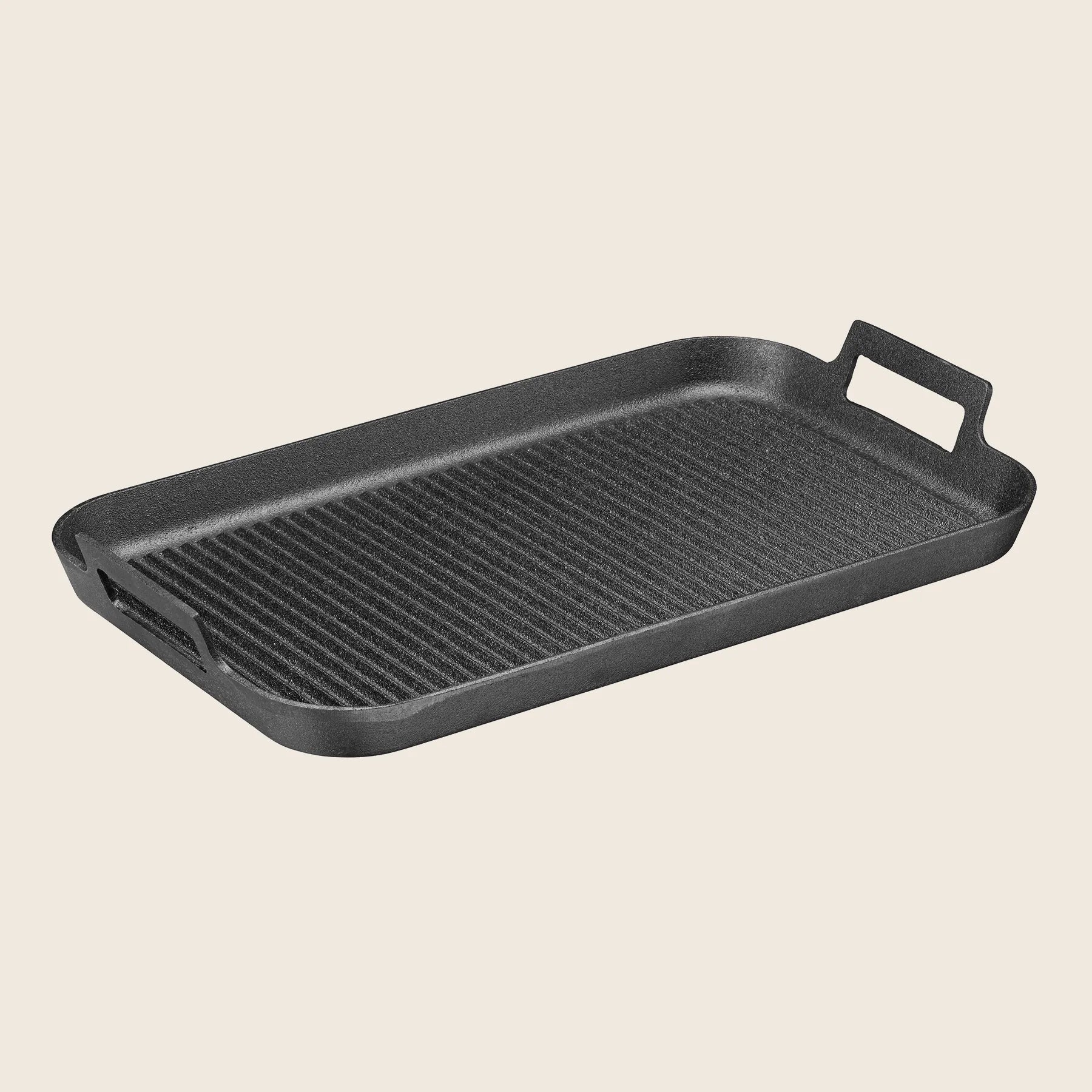 The Skeppshult Griddle is a rectangular cast iron grill pan with dual handles and a ridged surface, offering non-stick properties for seamless cooking.