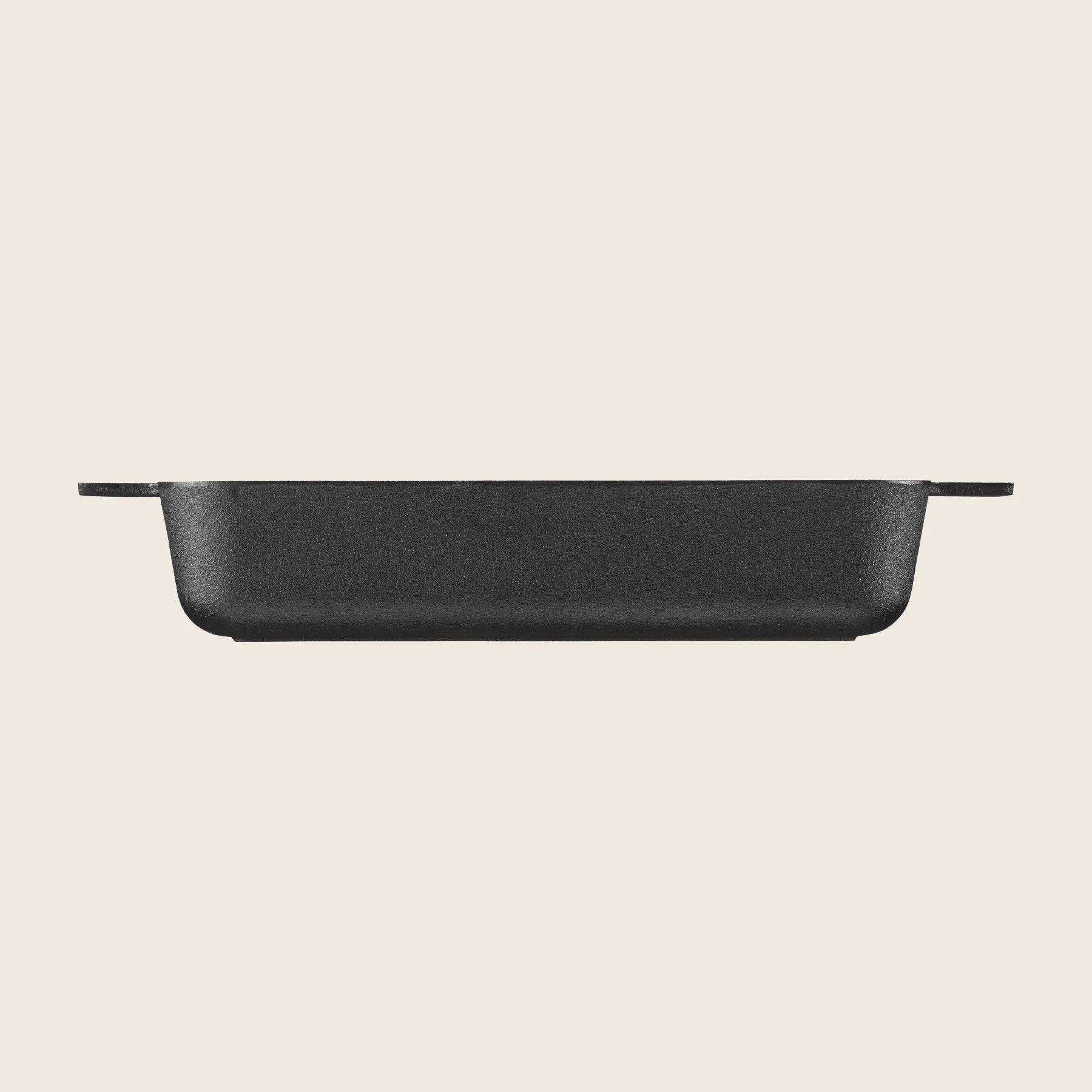 A side view of the black Skeppshult Oven Dish, made from cast iron with handles, set against a plain light background.