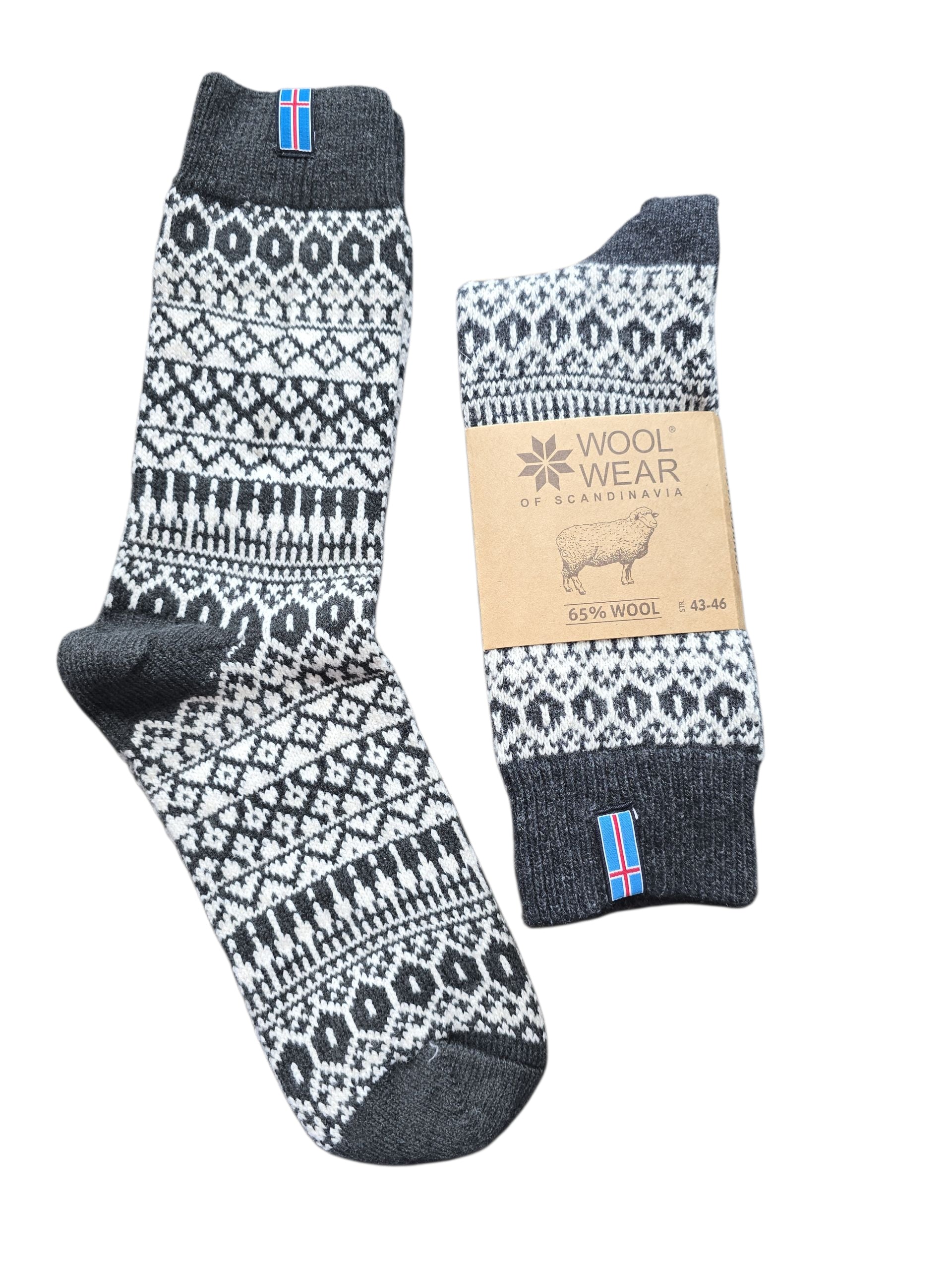The Socks: Wool Wear - Charcoal Iceland Flag – Wool Blend Socks feature a black and white pattern, a brown "Wool Wear of Scandinavia" label on one sock, and an Iceland flag tag for classic Scandinavian winterwear style.