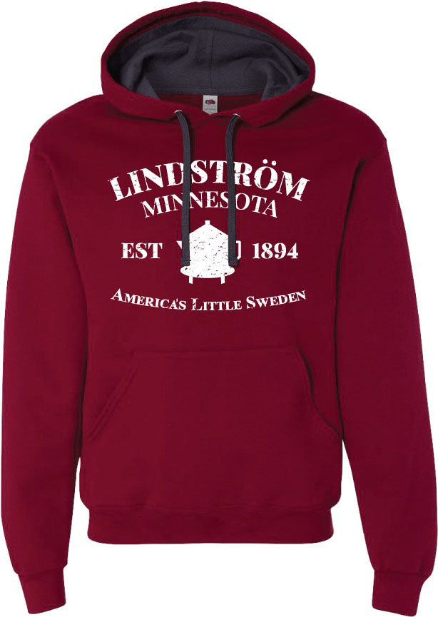 This Hoodie: Lindstrom Minnesota EST 1894 America's Little Sweden, celebrates the town known as America's Little Sweden since 1894. Made from a warm and comfortable 60/40 cotton polyester blend, it displays "Lindström Minnesota, Est 1894" in white text alongside a charming house image at the center.