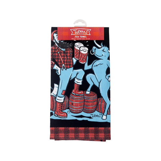 The Paul & Babe Cheers! Tea Towel by Adam Turman showcases Paul Bunyan and Babe the Blue Ox with figures in plaid holding mugs on barrels, under the Turman Tea Towel label.