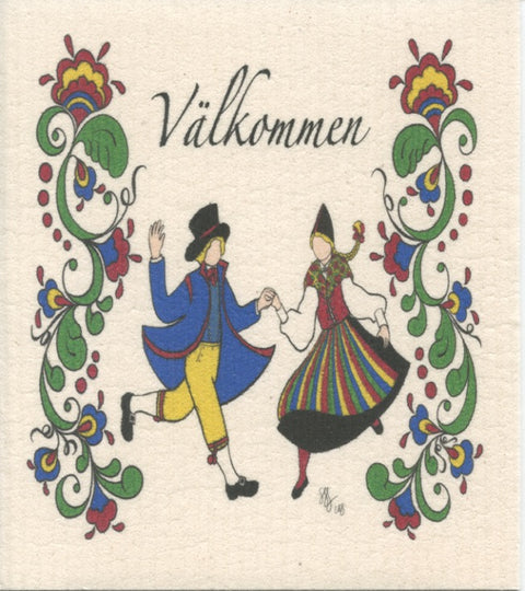 Using the captivating designs of the Dish Cloth: Valkommen Susan Swanson Swartz Dancers, two individuals in traditional attire are beautifully illustrated dancing, enveloped by floral patterns. The word "Välkommen" is proudly displayed at the top, reflecting their vibrant culture and commitment to sustainability.