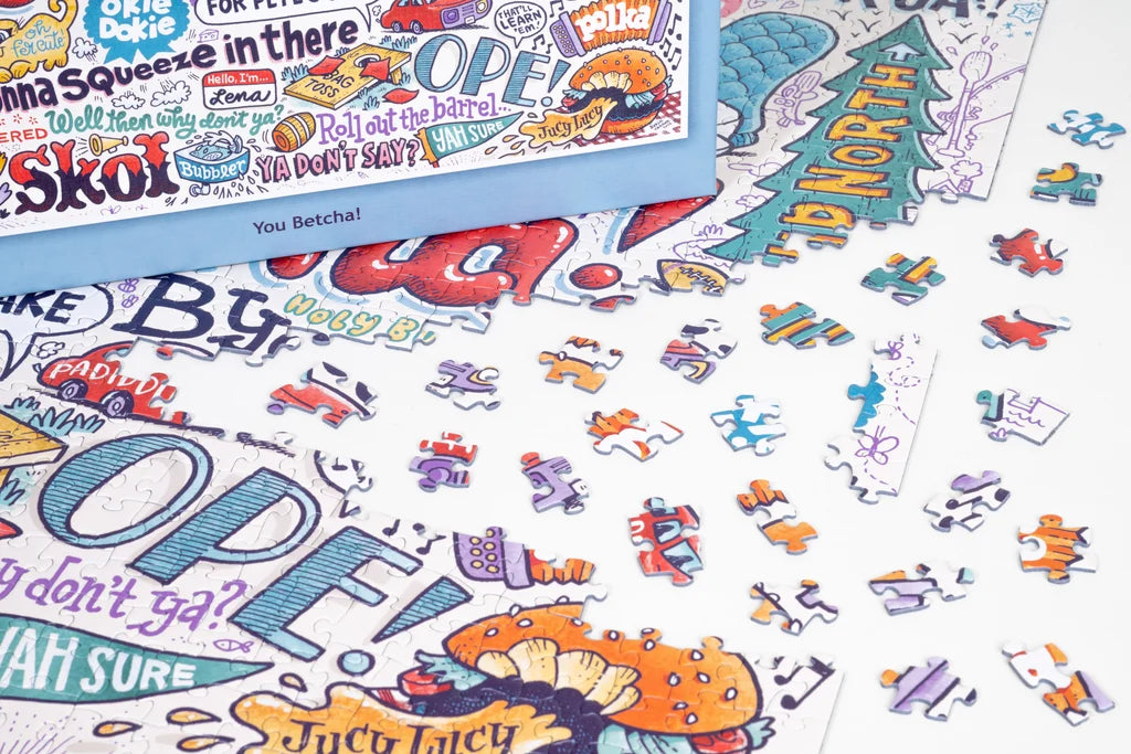 Jigsaw puzzle pieces with colorful, hand-drawn words and doodles on a white background, including visible text: OPEY, Juicy Lucy, and Hi North.