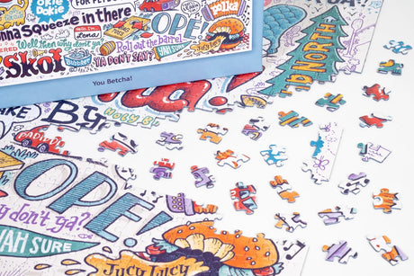 Jigsaw puzzle pieces with colorful, hand-drawn words and doodles on a white background, including visible text: OPEY, Juicy Lucy, and Hi North.