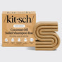 The KITSCH Coconut Oil Shampoo Bar for Dry Damaged Hair (3.2 oz) is uniquely designed in an abstract “S” shape and comes next to its tan packaging. Specially labeled as a moisturizing shampoo for kinky, curly, and coily hair, this solid bar highlights icons for bio-based ingredients, USA-made quality, cruelty-free standards, and sustainable sourcing. Infused with nourishing coconut oil, it helps enhance and care for your natural curl pattern.