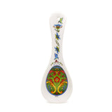 A green Norwegian rosemaling ceramic spoon rest with colorful floral patterns—perfect for adding Scandinavian charm to your kitchen decor.