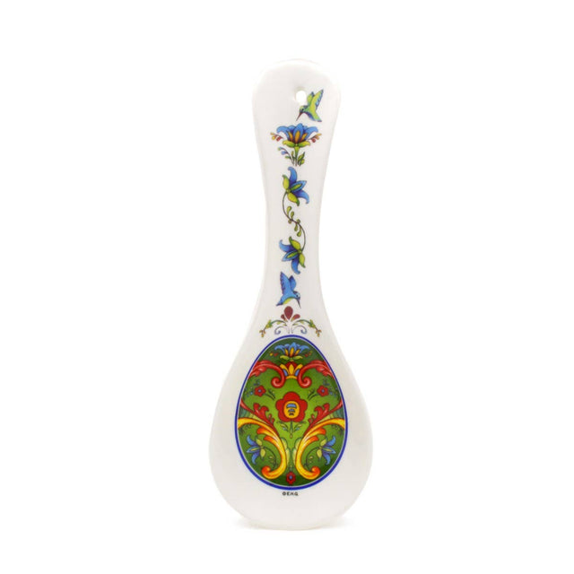 A green Norwegian rosemaling ceramic spoon rest with colorful floral patterns—perfect for adding Scandinavian charm to your kitchen decor.