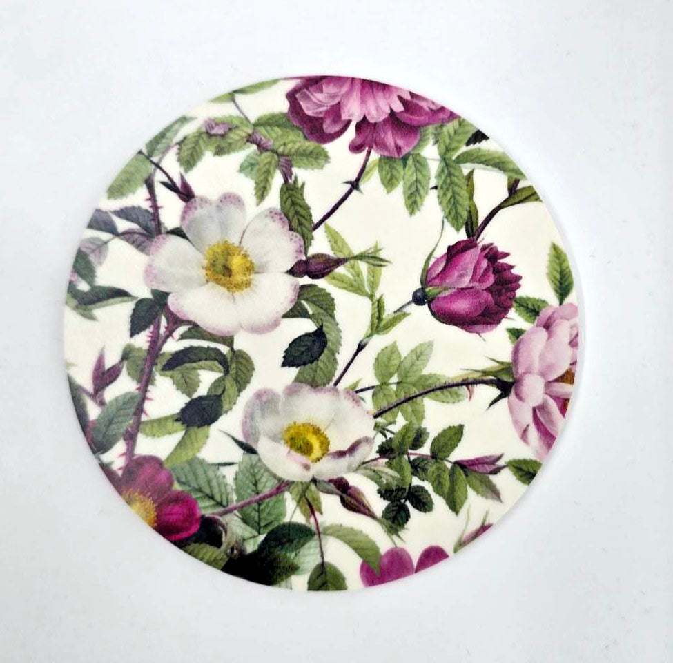 The Coaster: Rose Flower Garden 2-sided coaster, crafted from Nordic birch veneer by Jim Lyngvild Koustrupco, features circular floral designs of pink and white flowers with green leaves against a white background, blending elegance with environmental consciousness.