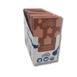 Box of caramel chocolate bars in a white display case, labeled soy-, gluten-, and palm-oil-free, with a visible USDA Organic logo.