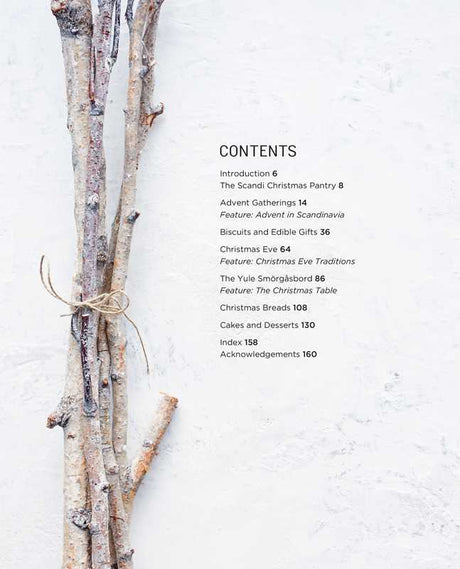 A bundle of sticks tied with twine sits on a light surface next to a contents page, reflecting Scandinavian tradition.