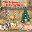Five animals in festive hats stand around a decorated Christmas tree inside a barn.
