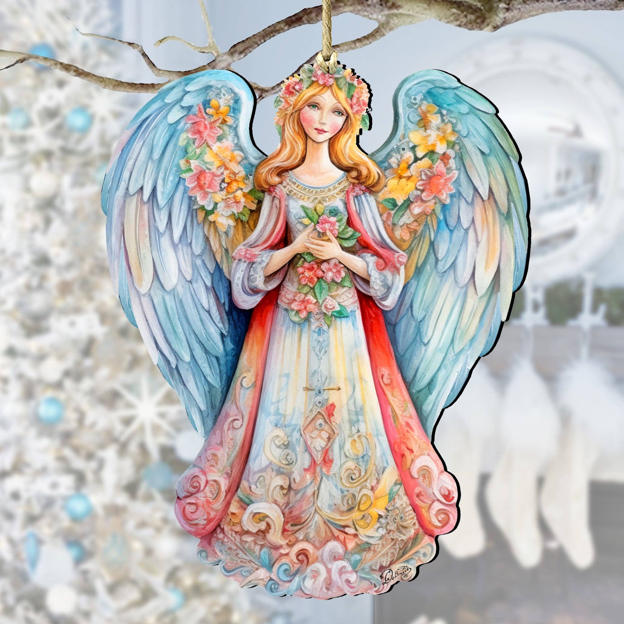 The Ornament: Angel Blue Floral Wooden Ornaments Debrekht Nativity Holiday, a meticulously crafted keepsake featuring colorful wings and floral decorations, hangs gracefully on a white Christmas tree.