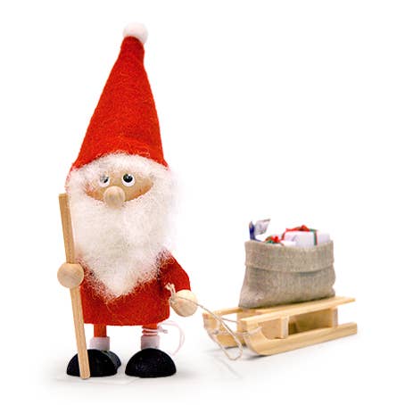 The Santa Gnome Gift Bag on Sled is a wooden figurine featuring a red-hatted, bearded Santa holding a stick beside a small sled loaded with a sack of gifts. This delightful decoration brings festive cheer to your Christmas tree, similar to charming Scandinavian gnomes.