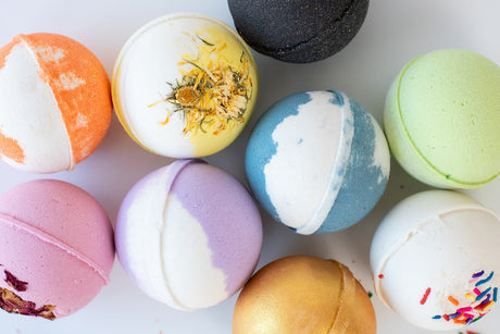 The Soap: Sandalwood & Vanilla Bath Bomb features vibrant colors, unique textures, and decorative toppings—perfect for elevating your bath time experience.