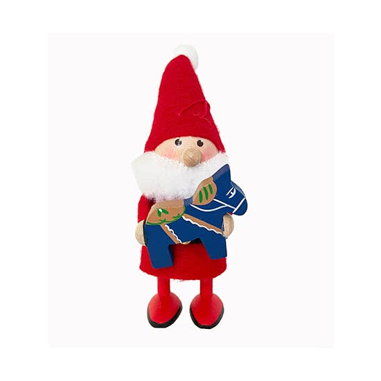 The Ornament: Red Santa with Blue Dala Horse captures the festive charm of Scandinavian gnomes, featuring a handcrafted Santa figurine with a red hat and holding a blue dala horse.