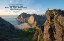 With "Wanderlust Nordics" in hand, Cam Honan stands on a cliff, taking in the breathtaking coastal landscape where rugged mountains merge with the tranquil ocean beneath a clear blue sky—a panorama that encapsulates the stunning hiking routes found throughout Nordic countries.