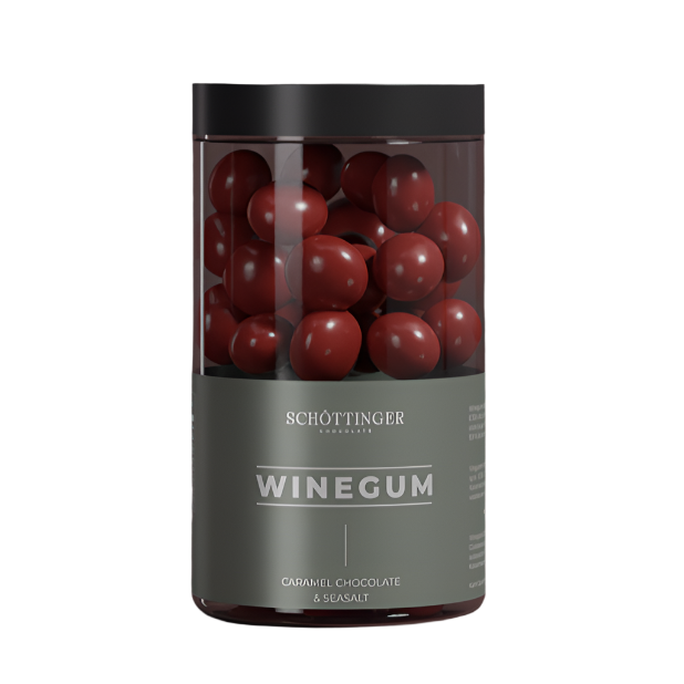 A jar labeled Candy: Classic Winegum Seasalt & Caramel Chocolate 250 g, filled with round, red-amber winegums, stands elegantly. The label hints at the delightful fusion within.