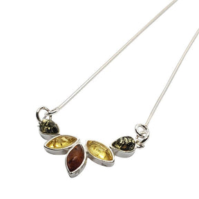 A 17 sterling silver necklace with five marquise teardrop pendants featuring multi-color Baltic amber stones in warm yellow and brown hues.