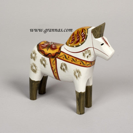 The Antique Inspired Dala Horse in White/Green, a symbol of Swedish traditional craft, boasts intricate patterns against a plain background. This exquisite piece is hand-carved and painted to perfection.