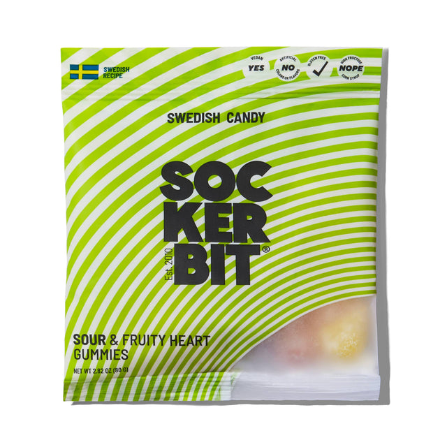 A 2.8oz bag of Sockerbit Sour Fruity Heart Gummies Swedish Candy features green and white stripes, a Swedish flag, non-GMO labeling, ingredient information, and a partially visible gummy heart inside.