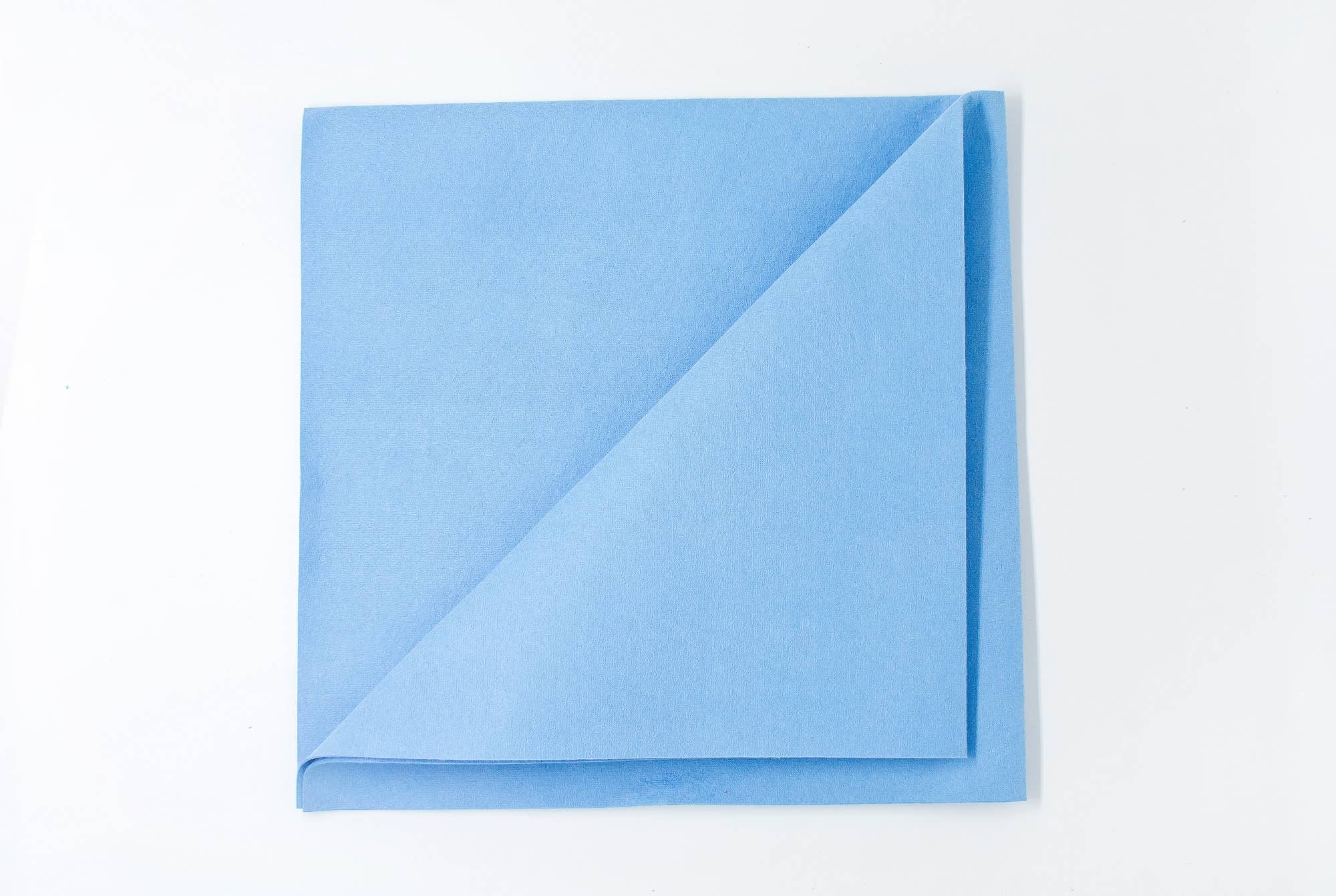 A Streak Free Cloth Euroscrubby, perfect for streak-free cleaning, is neatly folded in half diagonally on a pristine white background.