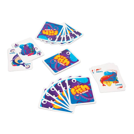 Stacks and hands of vibrant Game: Go Fish Card Game cards featuring cartoon sea creatures, including octopus and fish, are displayed on a white surface for an underwater-themed adventure.