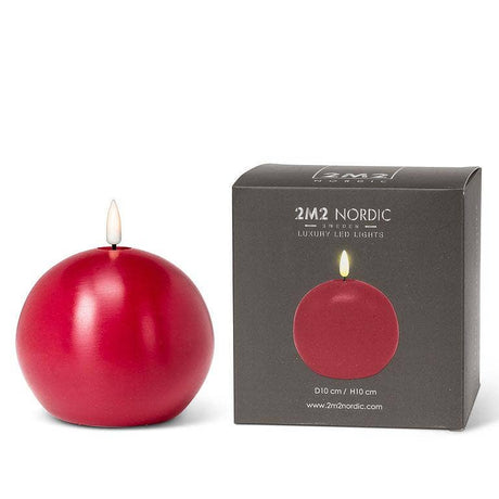 A red spherical LED candle next to its dark gray packaging.