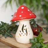 The Candle Holder: Mushroom Tealight Candle Holder – Ceramic Nordic Accent (6" Tall × 4.5" Wide) features a red cap with white spots and cut-out designs, making it a charming ceramic décor piece for any space.