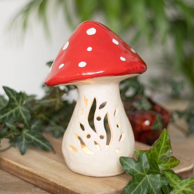 The Candle Holder: Mushroom Tealight Candle Holder – Ceramic Nordic Accent (6" Tall × 4.5" Wide) features a red cap with white spots and cut-out designs, making it a charming ceramic décor piece for any space.