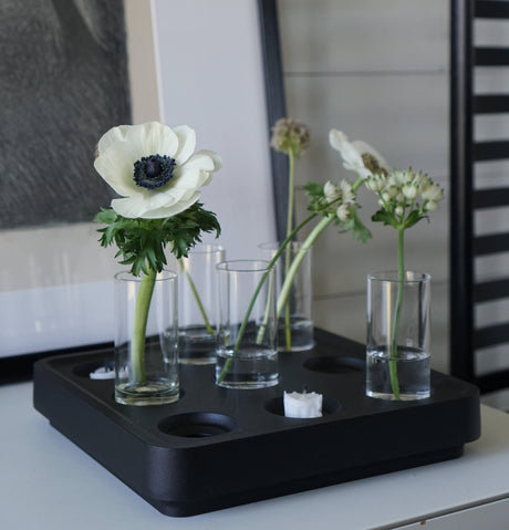 The Candle Holder: Mini Vases for Stumpastaken Candleholder 2-pack, displayed on a black tray with white blooms and a tealight, creates an elegant table accent atop a light surface with framed art in the background.