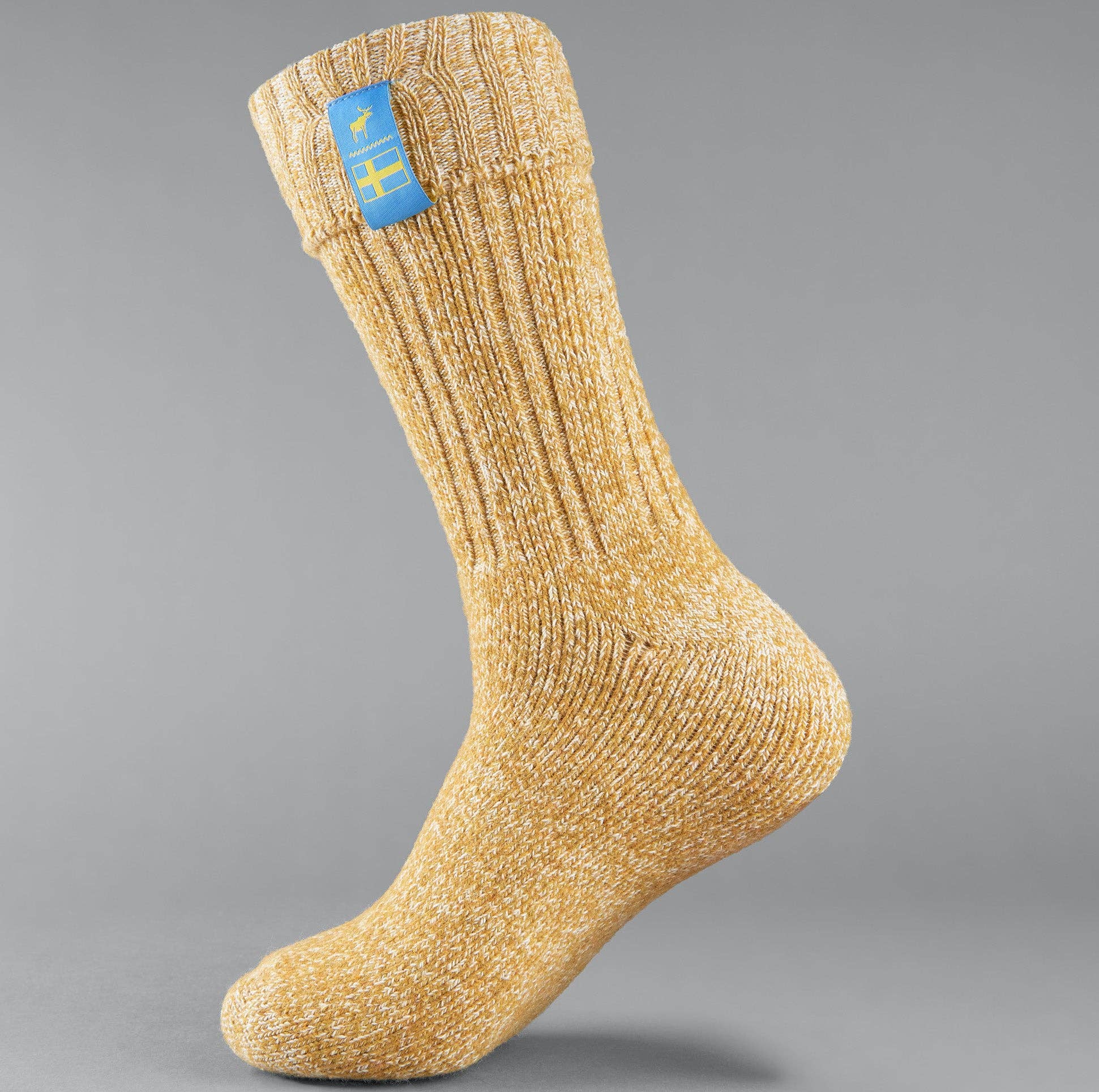 A single Swedish Lagom wool blend sock in yellow, adorned with a blue tag against a gray backdrop, promising premium comfort for unisex apparel enthusiasts.