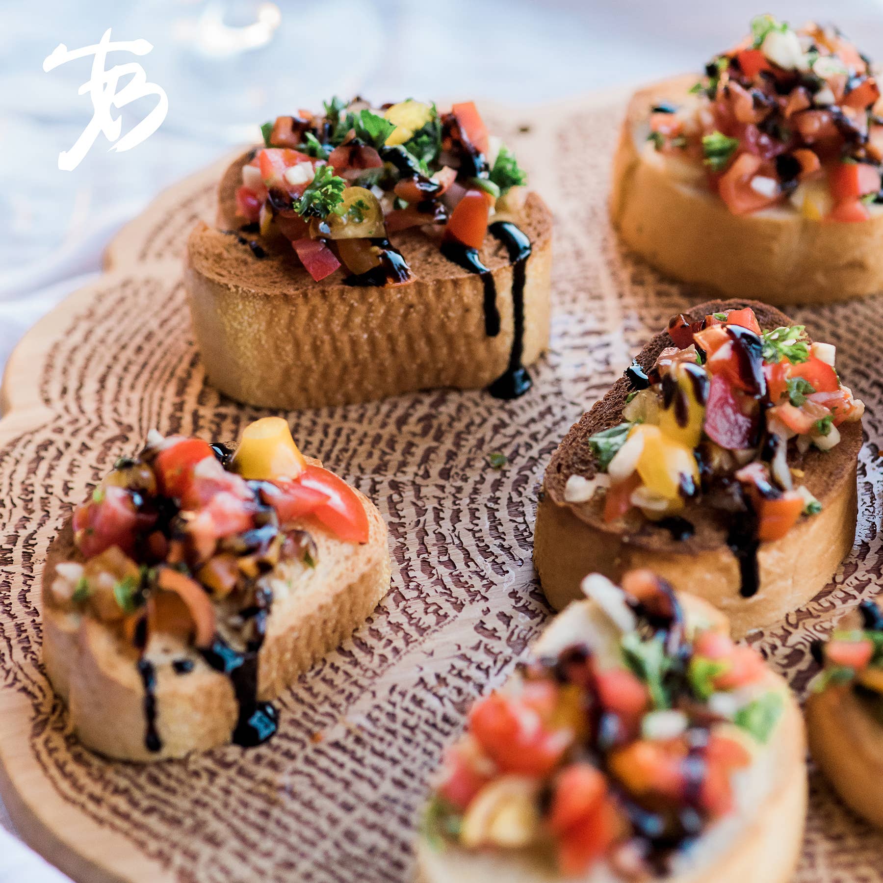 The Serving Board: Tree Of Life 13" elegantly displays a wooden platter adorned with bruschetta, finely topped with diced tomatoes, herbs, and balsamic glaze.