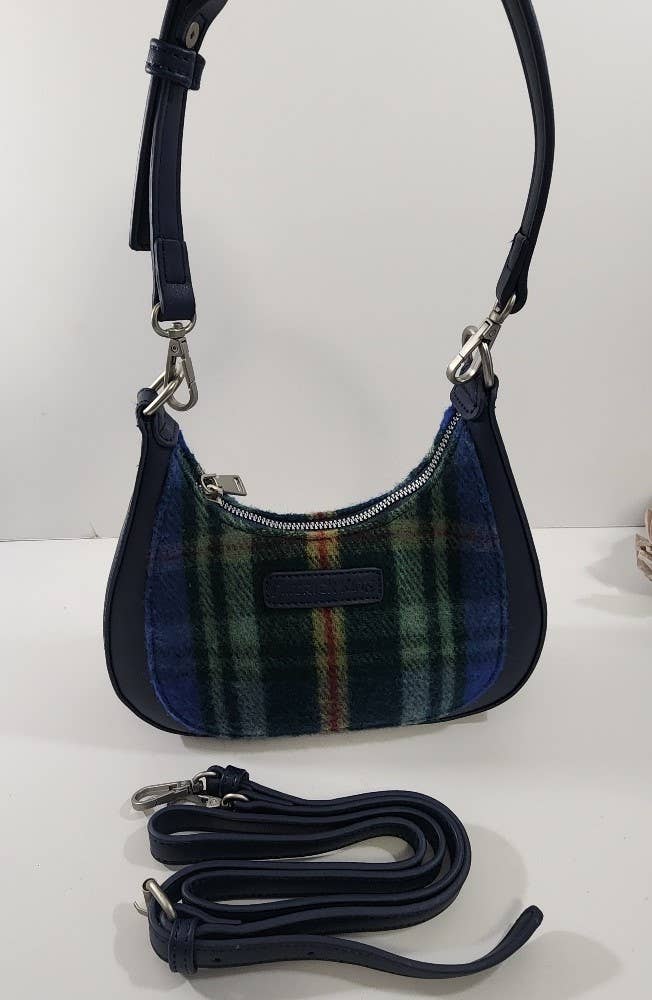 The Bag: Tartan Merino Wool Bag - Nova Scotia features a blue, green, and red tartan pattern, silver zipper, and detachable black leather strap, displayed on a white surface.