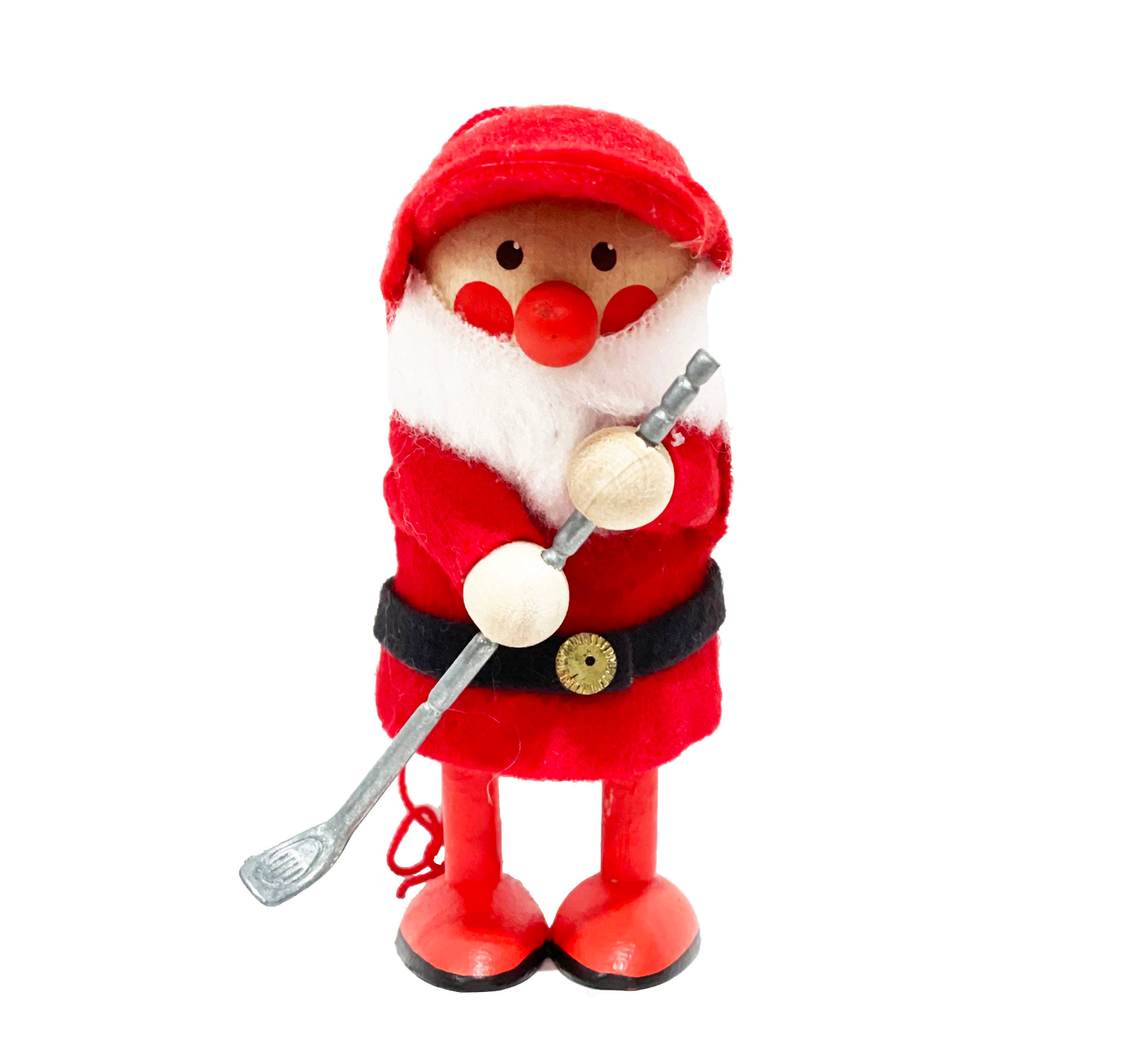 Golf enthusiasts will love the Scandinavian touch of this Santa Golf Player wooden figurine, dressed in a red suit, black belt, and matching hat, holding his golf club ready for play.