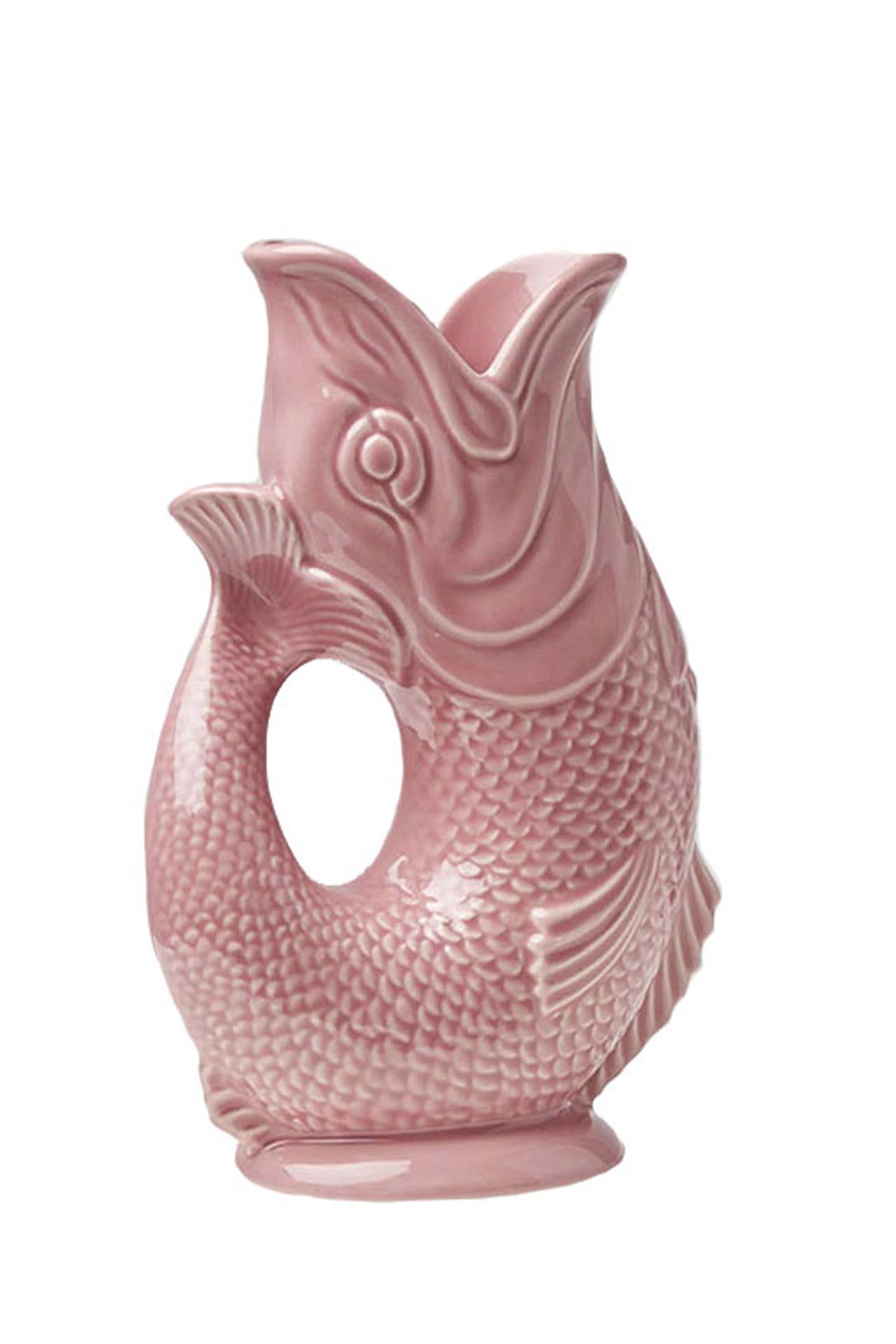 The Gluggle Jug: Pink is a whimsical ceramic jug designed in the shape of a fish, featuring detailed scales and an open mouth, making it an ideal piece of novelty dinnerware.