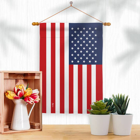 The United States of America Garden Flag - USA Nationality Home Decor Flag hangs above a table with flowers and succulents, bringing American pride to the decor.