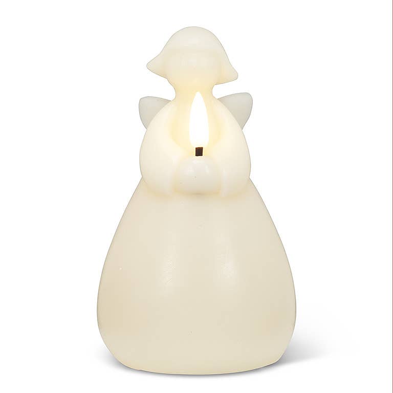 An ivory 6" Angel LED Candle from the candle holder creates an ambient glow, offering a serene atmosphere.