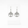 The Tree of Life Round Drop Silver Earrings feature handcrafted round silver dangle designs, shown on a clear stand with a white background.