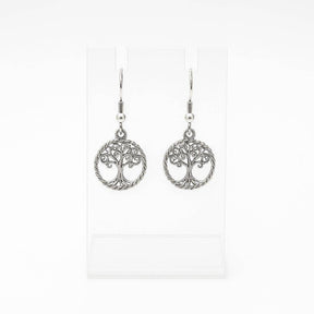 The Tree of Life Round Drop Silver Earrings feature handcrafted round silver dangle designs, shown on a clear stand with a white background.