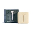 Bar of exfoliating Palo Santo Soap featuring an axe design, positioned next to its coordinating box adorned with the identical axe motif and text.